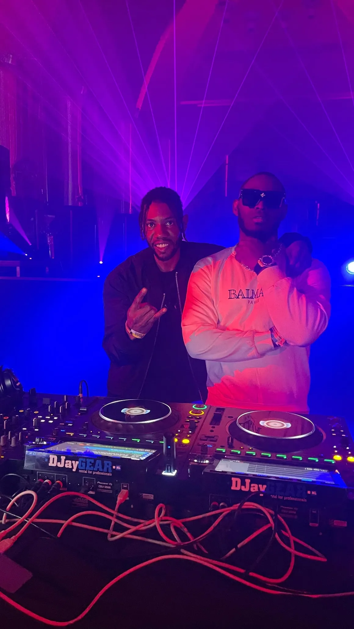 DJs at the decks - blue and pink lights